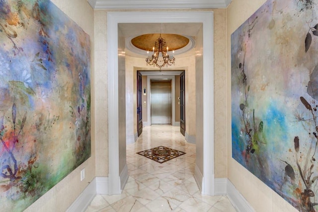 hall with a notable chandelier, crown molding, and a raised ceiling