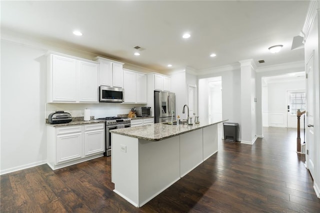 60 Copeland Trce, Dallas, GA 30157 - kitchen featuring appliances with stainless steel finishes, ornamental molding, a sink, an island with sink, and light stone countertops