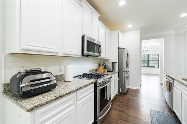 60 Copeland Trce, Dallas, GA 30157 - kitchen featuring stainless steel appliances, ornamental molding, tasteful backsplash, white cabinets, and a chandelier