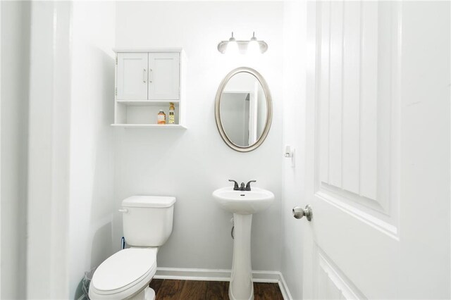 60 Copeland Trce, Dallas, GA 30157 - bathroom featuring toilet, baseboards, wood finished floors, and a sink