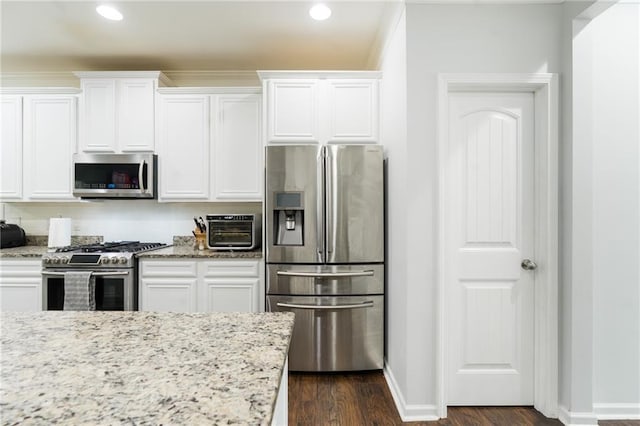 60 Copeland Trce, Dallas, GA 30157 - kitchen with appliances with stainless steel finishes, white cabinets, dark wood-type flooring, light stone counters, and recessed lighting