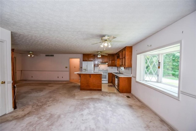 3223 Heritage Way, Buford, GA 30519 - kitchen featuring white appliances, ceiling fan, brown cabinets, a kitchen island, and a textured ceiling