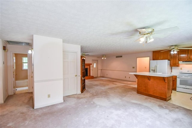 3223 Heritage Way, Buford, GA 30519 - kitchen featuring white appliances, extractor fan, a breakfast bar area, brown cabinetry, and light countertops