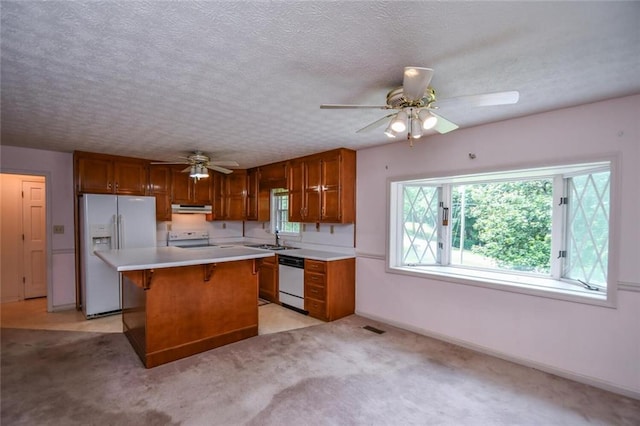 3223 Heritage Way, Buford, GA 30519 - kitchen with white fridge with ice dispenser, dishwasher, range, ceiling fan, and under cabinet range hood