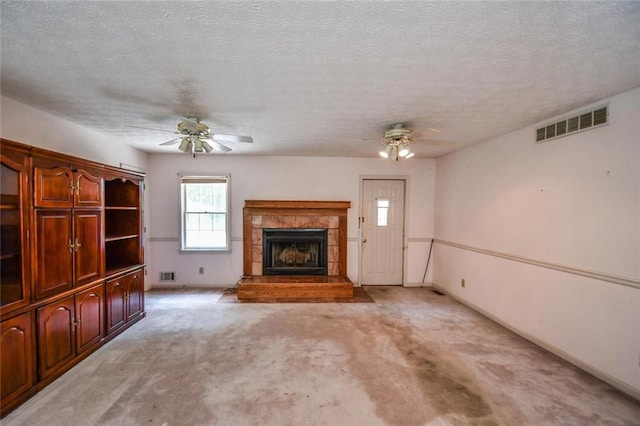 3223 Heritage Way, Buford, GA 30519 - unfurnished living room featuring ceiling fan, a tile fireplace, light colored carpet, and a textured ceiling