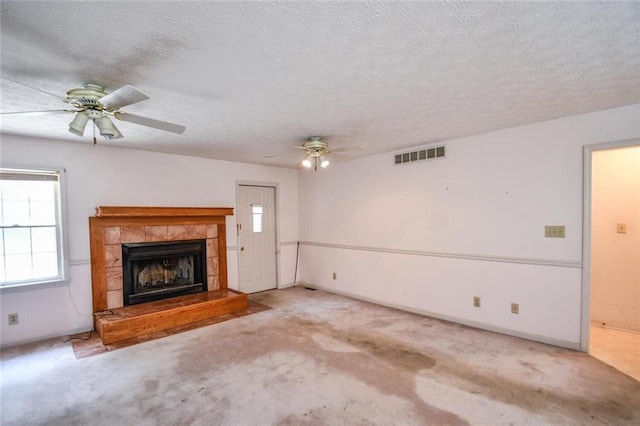 3223 Heritage Way, Buford, GA 30519 - unfurnished living room with a ceiling fan, carpet floors, a tiled fireplace, a textured ceiling, and baseboards