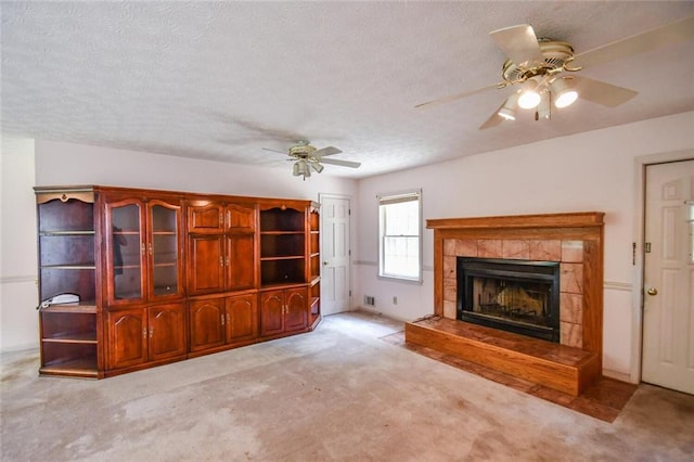 3223 Heritage Way, Buford, GA 30519 - unfurnished living room featuring carpet, ceiling fan, a fireplace, and a textured ceiling