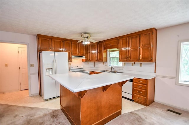 3223 Heritage Way, Buford, GA 30519 - kitchen featuring white appliances, under cabinet range hood, a sink, ceiling fan, and brown cabinets