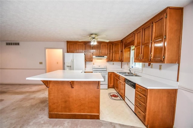 3223 Heritage Way, Buford, GA 30519 - kitchen featuring white appliances, a sink, ceiling fan, under cabinet range hood, and a center island