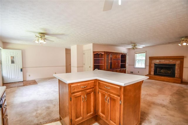 3223 Heritage Way, Buford, GA 30519 - kitchen with a ceiling fan, light carpet, open floor plan, a tiled fireplace, and light countertops