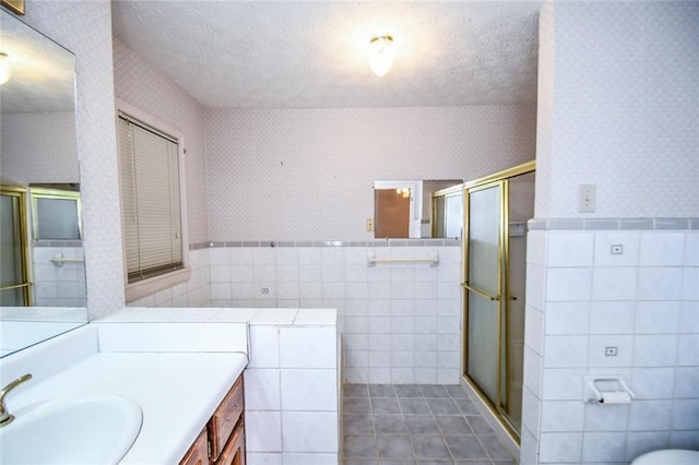 3223 Heritage Way, Buford, GA 30519 - bathroom with tile walls, wallpapered walls, a textured ceiling, vanity, and tile patterned flooring