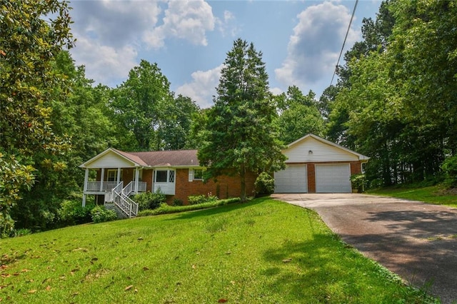 3223 Heritage Way, Buford, GA 30519 - ranch-style house with covered porch, a front lawn, stairway, concrete driveway, and brick siding