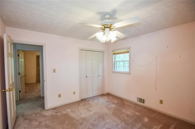 3223 Heritage Way, Buford, GA 30519 - unfurnished bedroom featuring light colored carpet, baseboards, a closet, and ceiling fan