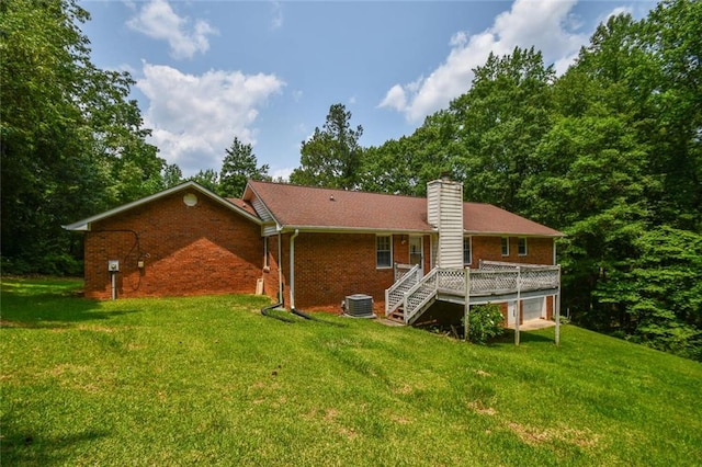 3223 Heritage Way, Buford, GA 30519 - rear view of house with brick siding, a wooden deck, and a lawn