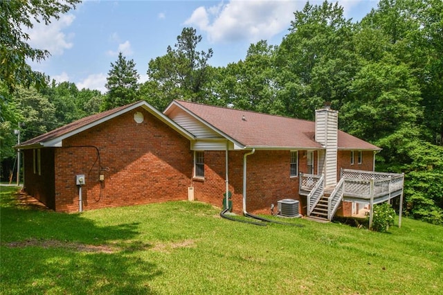 3223 Heritage Way, Buford, GA 30519 - rear view of property with central AC unit, brick siding, and a lawn