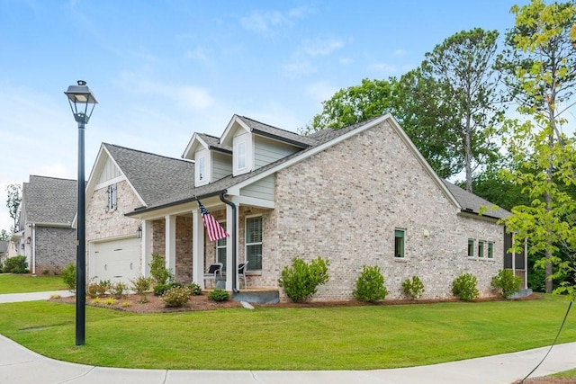 view of front of property featuring covered porch, a front lawn, and a garage