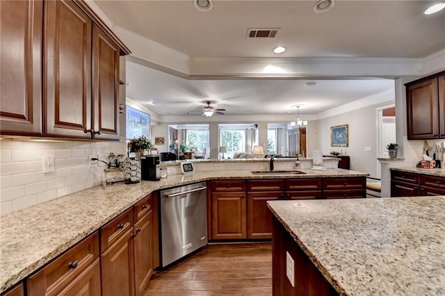 kitchen featuring a sink, crown molding, visible vents, and dishwasher