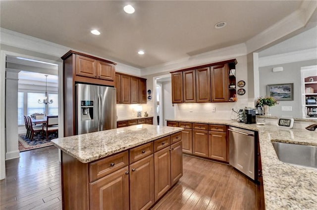 kitchen with ornamental molding, stainless steel appliances, light wood-type flooring, open shelves, and a sink