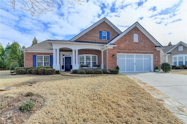 view of front of home featuring a porch, brick siding, driveway, and a garage