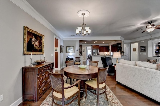 dining space with dark wood-type flooring, visible vents, ornamental molding, and baseboards