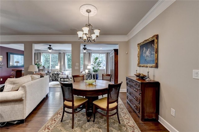 dining room featuring dark wood-type flooring, crown molding, baseboards, and an inviting chandelier