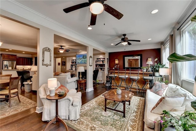 living room featuring ornamental molding, wood finished floors, and recessed lighting