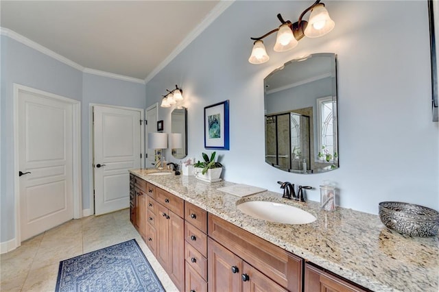 bathroom featuring a sink, tile patterned floors, double vanity, a stall shower, and crown molding