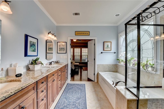 bathroom with double vanity, ornamental molding, a garden tub, and visible vents