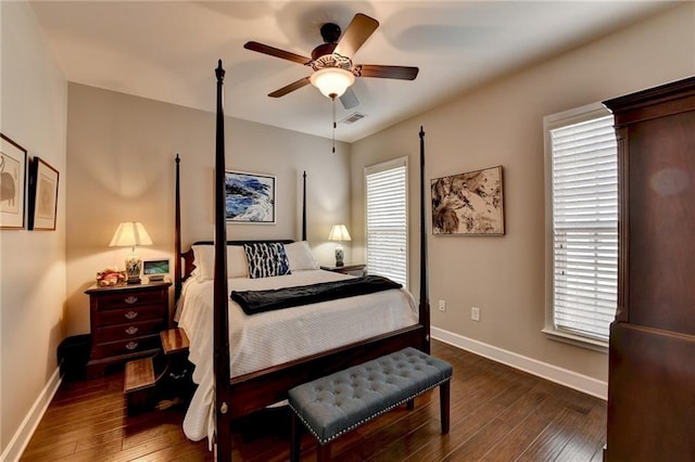 bedroom with a ceiling fan, baseboards, visible vents, and hardwood / wood-style floors