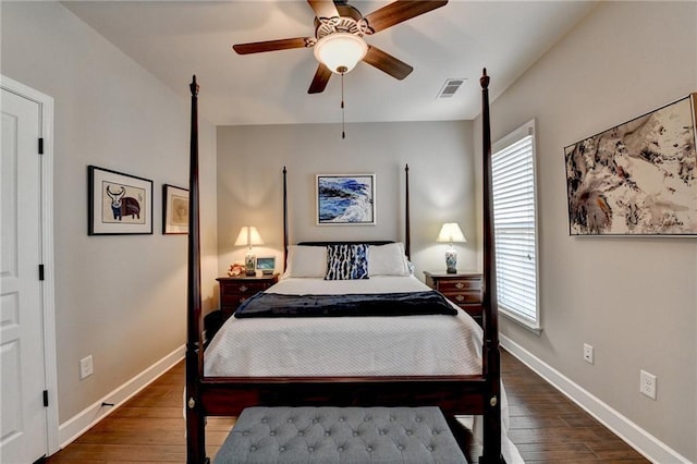 bedroom with baseboards, visible vents, ceiling fan, and wood finished floors