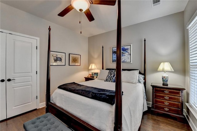 bedroom featuring visible vents, ceiling fan, baseboards, and wood finished floors