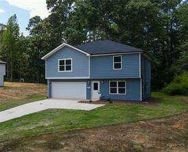 view of front of home with a front lawn and a garage