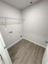 laundry area with hookup for an electric dryer, hookup for a washing machine, and dark hardwood / wood-style floors