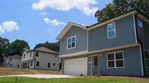 view of front of home with a garage and a front lawn