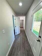 corridor featuring dark hardwood / wood-style floors