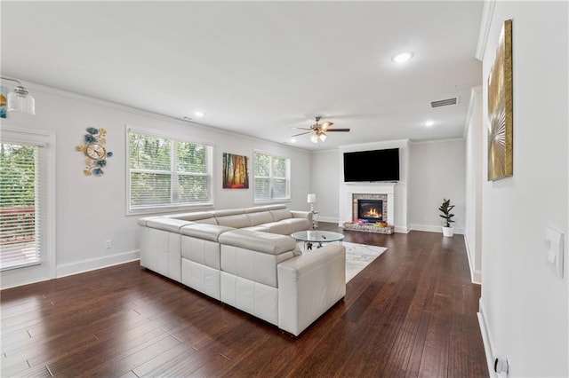 5545 Adirondack Dr, Cumming, GA 30040 - living room featuring a ceiling fan, ornamental molding, a brick fireplace, dark wood-type flooring, and recessed lighting