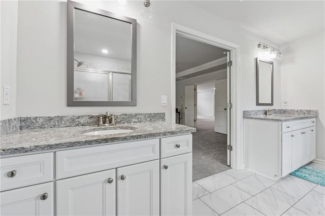 5545 Adirondack Dr, Cumming, GA 30040 - full bathroom with two vanities, a shower stall, marble finish floors, and crown molding