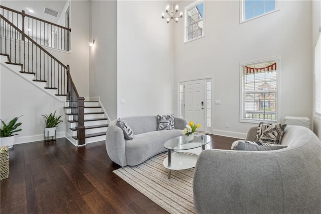 5545 Adirondack Dr, Cumming, GA 30040 - living room featuring hardwood / wood-style floors, a towering ceiling, stairway, and a chandelier