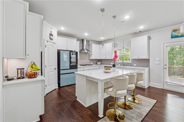 5545 Adirondack Dr, Cumming, GA 30040 - kitchen featuring wall chimney exhaust hood, freestanding refrigerator, backsplash, dark wood-style flooring, and recessed lighting
