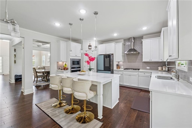 5545 Adirondack Dr, Cumming, GA 30040 - kitchen featuring stainless steel appliances, wall chimney range hood, backsplash, a center island, and light countertops
