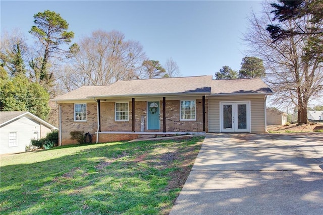 single story home with french doors, brick siding, a porch, and a front lawn