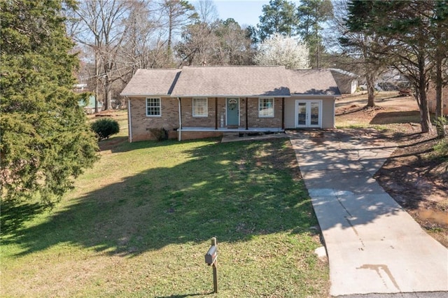 ranch-style home with brick siding, a porch, and a front yard