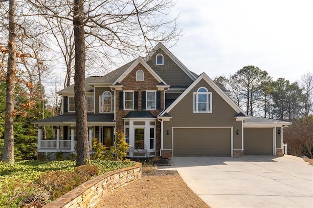 view of front facade with a garage, covered porch, and concrete driveway