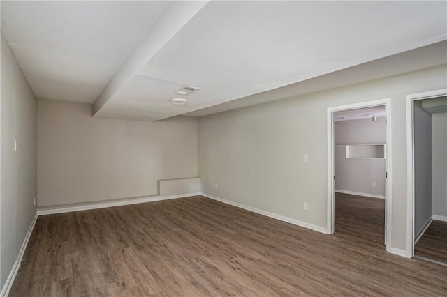 unfurnished room with visible vents, baseboards, and wood finished floors