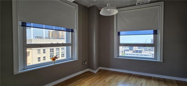 empty room with wood finished floors and baseboards