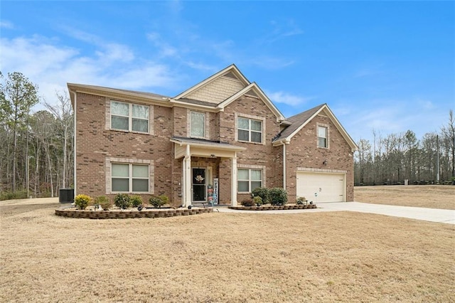 view of front of home featuring cooling unit, a garage, and a front lawn