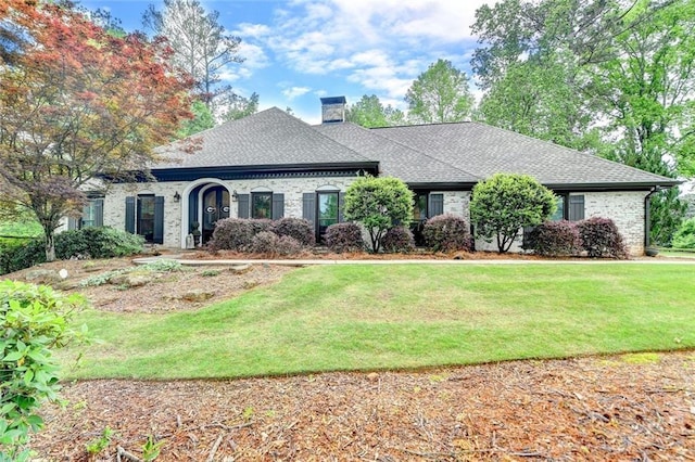 5475 Trowbridge Dr, Dunwoody, GA 30338 - ranch-style house with a chimney, a front yard, a shingled roof, and brick siding