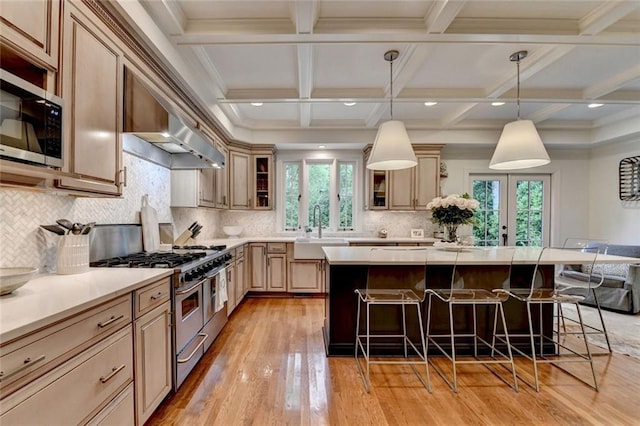 5475 Trowbridge Dr, Dunwoody, GA 30338 - kitchen featuring a kitchen bar, stainless steel appliances, a healthy amount of sunlight, and a sink