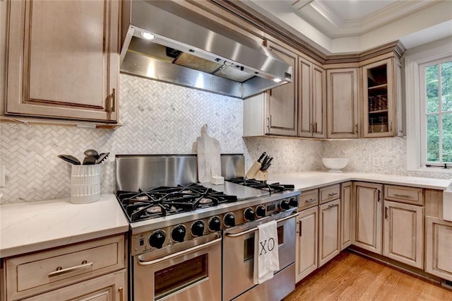 5475 Trowbridge Dr, Dunwoody, GA 30338 - kitchen featuring range with two ovens, light wood-type flooring, wall chimney exhaust hood, backsplash, and ornamental molding