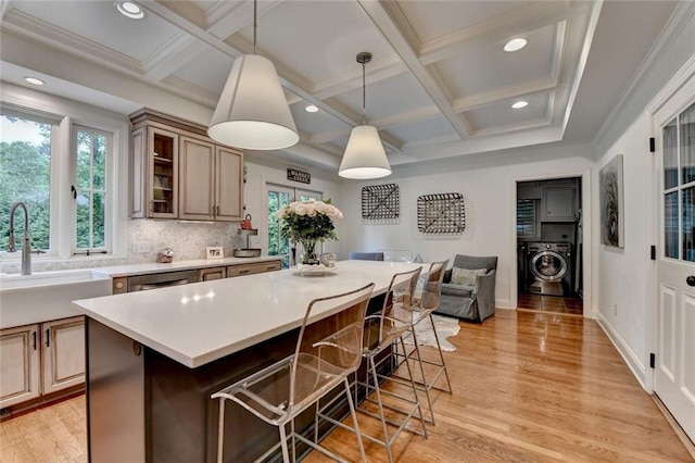 5475 Trowbridge Dr, Dunwoody, GA 30338 - kitchen with a breakfast bar, plenty of natural light, coffered ceiling, and a sink